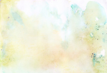 Light blue and green abstract watercolor background with blurred stains and drips
