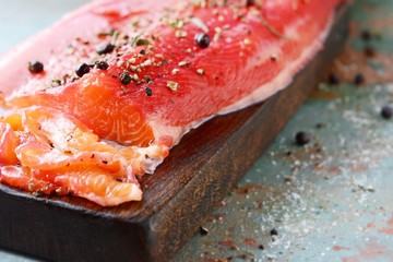 Gravlax, scandinavian beet cured spiced salmon on the board, top view, salted red fish