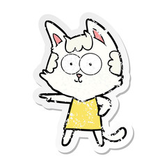 distressed sticker of a happy cartoon cat in dress pointing
