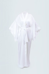 Silk female long white robe isolated on grey