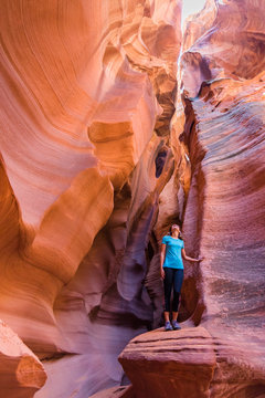 Young Woman In Antelope Canyon In Arizona. Tourist In Antelope Canyon. Adventure And Hiking Concept.