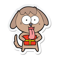 sticker of a cute cartoon dog with christmas present