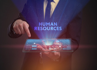 The concept of business, technology, the Internet and the network. A young entrepreneur working on a virtual screen of the future and sees the inscription: Human resources