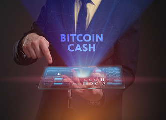 The concept of business, technology, the Internet and the network. A young entrepreneur working on a virtual screen of the future and sees the inscription: Bitcoin cash