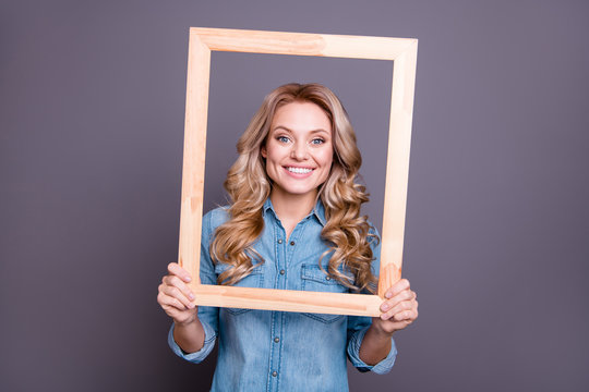 Portrait of her she nice-looking cute charming winsome fascinating attractive cheerful cheery wavy-haired lady holding in hands frame comfort cozy life zone isolated over gray background