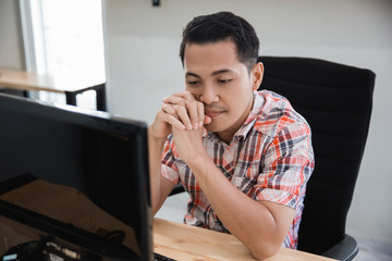 man losing and stress. asian businessman feeling depress while looking at his computer in the office
