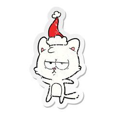bored distressed sticker cartoon of a cat wearing santa hat