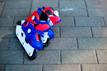 Close up photo of legs in blue inline skates standing