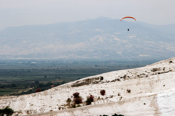 Famous and amazing thermal springs Pamukkale or Cotton Castle on Denizli Province in Turkey and Paragliding