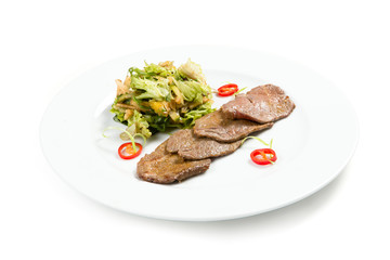 Salad with beef on a white plate
