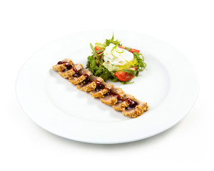 Salad with baked salmon in sesame on white