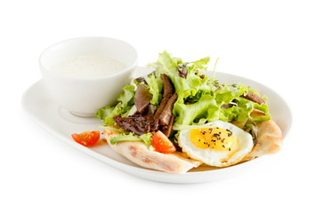 pita bread with egg, meat and green salad