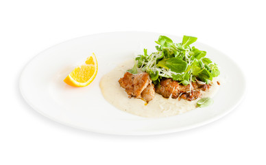 Fried meat with herbs and lemon on a plate