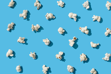 Popcorn on blue background. Texture.