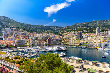 Fototapeta na wymiar Yachts in bay near houses and hotels, La Condamine, Monte-Carlo, Monaco, Cote d'Azur, French Riviera