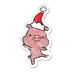 distressed sticker cartoon of a furious pig wearing santa hat