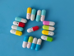 Happy smiley made of drugs on blue background (life style) 