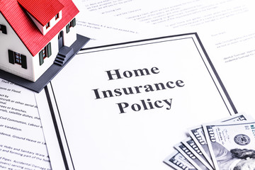 Close-up of a house model with dollar notes. Mortgage concept. Home insurance policy