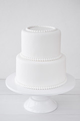White wedding cake blank on a white background. Simple minimalism.