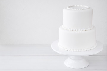 White wedding cake blank on a white background. Simple minimalism.