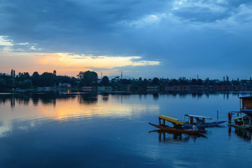Fototapeta na wymiar The beauty of Dal lake and the beautiful Shikaras during sunrise and sunset is the most charming thing in Kashmir