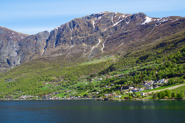Naklejka na ściany i meble The village of Aurlandsvangen at the coast of the Sogne fjord (Aurlands fjord)