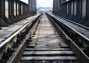 Fototapeta na wymiar railway rails on a metal bridge go into perspective