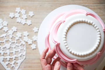 Making and decorating wedding cake with elements from pastry mastic. Top view. Cooking ingredients. Mockup for menu, recipe or culinary classes.