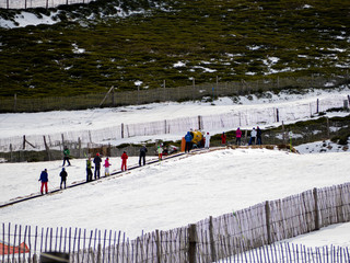 Unrecognizable people practicing skiing in the snow on a ski slope on the mountain on La Covatilla, Bejar (Salamanca)