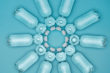 top view of plastic water bottles with bubbles isolated on turquoise