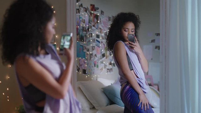 beautiful teenage girl taking selfie photo using smartphone posing in mirror sharing stylish fashion on social media enjoying weekend at home teen self image