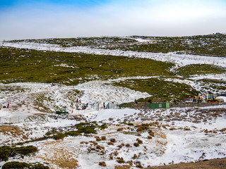 Unrecognizable people gliding on the ice in a slope on the mountain on La Covatilla, Bejar (Salamanca)