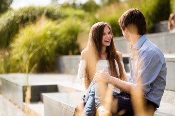 Romantic love fun couple sitting outside in park
