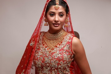 Indian bride in traditional bridal sari in studio lighting indoor