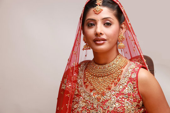 Indian bride in traditional bridal sari in studio lighting indoor