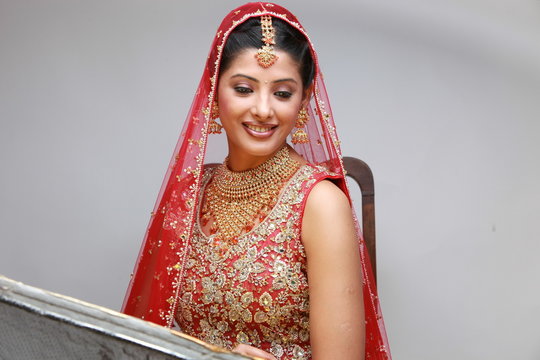 Indian bride in traditional bridal sari in studio lighting indoor
