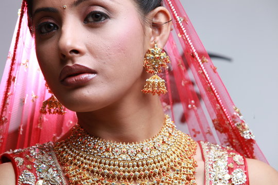 Indian bride in traditional bridal sari in studio lighting indoor