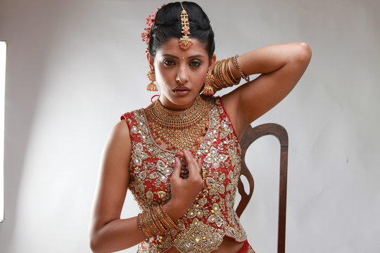 Indian bride in traditional bridal sari in studio lighting indoor