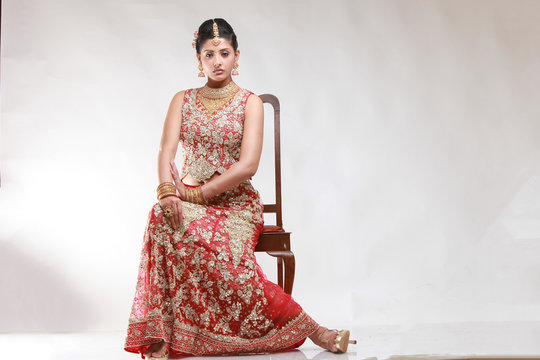 Indian bride in traditional bridal sari in studio lighting indoor