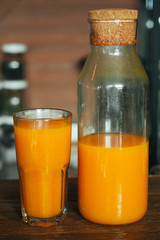 sea buckthorn juice in glass and jug