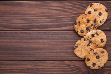 Chocolate cookies on brown background. Chocolate chip cookies shot