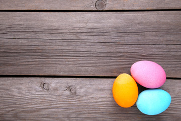 Colorful easter eggs on a grey wooden background