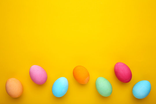 Colorful easter eggs on a yellow background