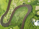 Aerial landscape of winding river in green fields