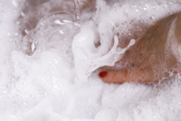 	The hand foamed with soapsuds during the washing.