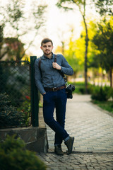 Fototapeta premium Professional photographer with camera stand outside and wait for the model