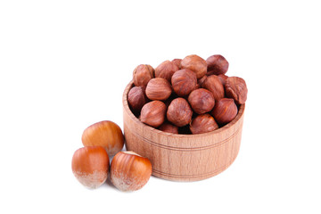 Delicious hazelnut in the wooden bowl isolated on white background