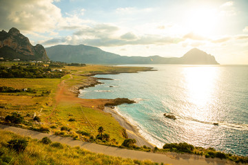 View of mountains and blue sea in the Italian natural reserve or Riserva dello Zingaro at sunset lights in Sicily, Italy
