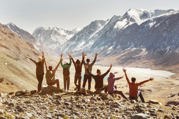 Big active company of happy friends in mountains