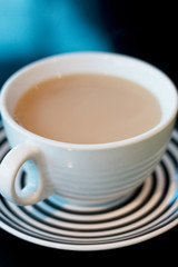 Cup of white milky teas in a white cup. Hot drink in cup.
